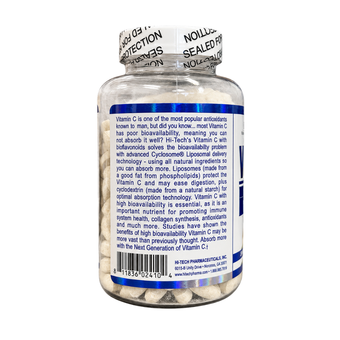 A clear plastic bottle of Hi-Tech Pharmaceuticals Vitamin C capsules, showing the white and blue label details, including a barcode and product description, on a white background.
